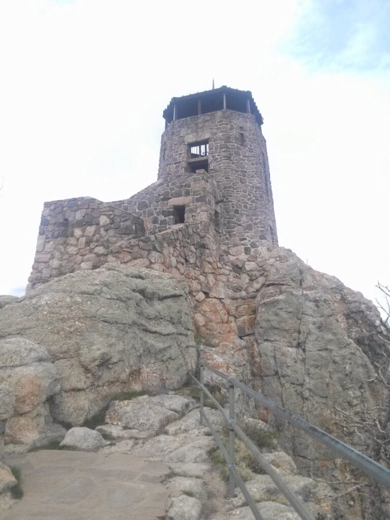 Historic stone fire lookout tower on the summit of Black Elk Peak, a popular hike in Custer State Park, South Dakota.