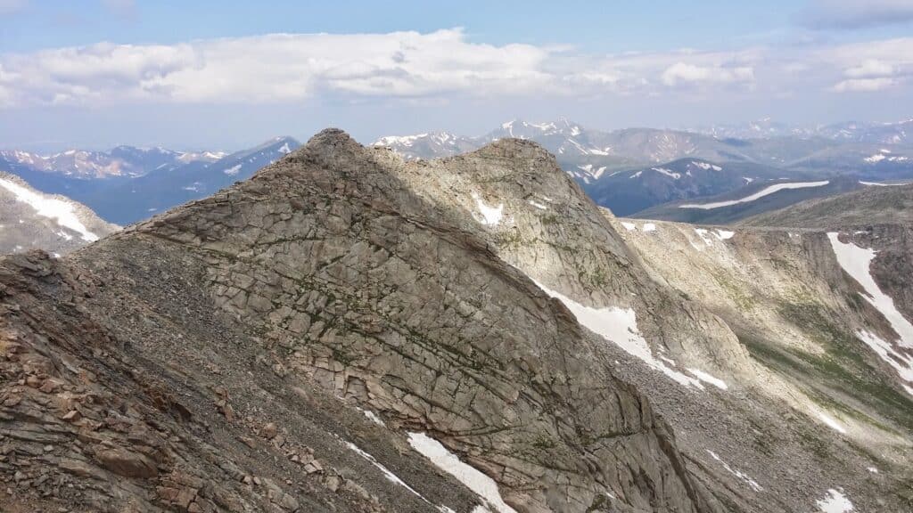 Mount Blue Sky, formerly Mount Evans, a Colorado mountain looms in the foreground with more Rocky Mountain peaks in the distance.