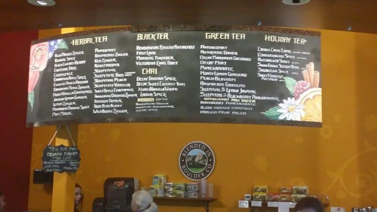 Menu board of herbal, black, green, holiday, and chai tea varieties available for tasting after the Celestial Seasonings Tour at the Boulder Tea Factory.