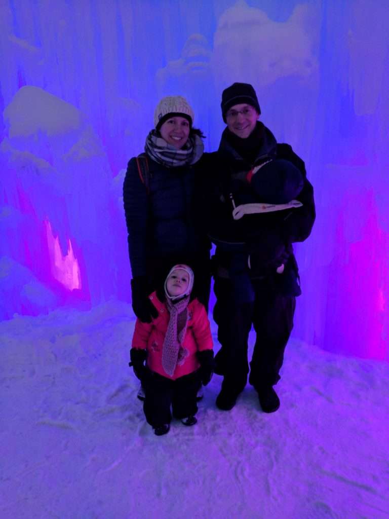 Our family in front of a wall lit by blue and pink light