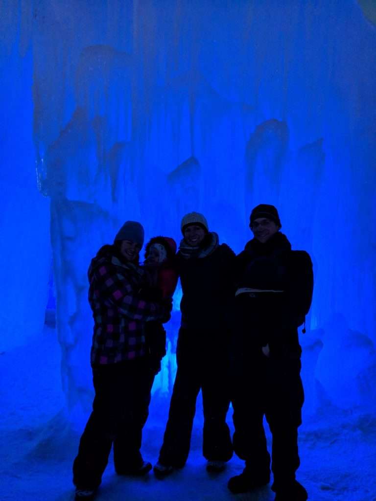 Our group in front of a wall lit by blue light