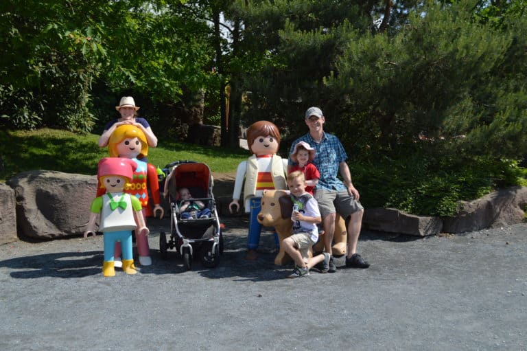 A family standing among Playmobil Figurines at Playmobil Funpark Germany