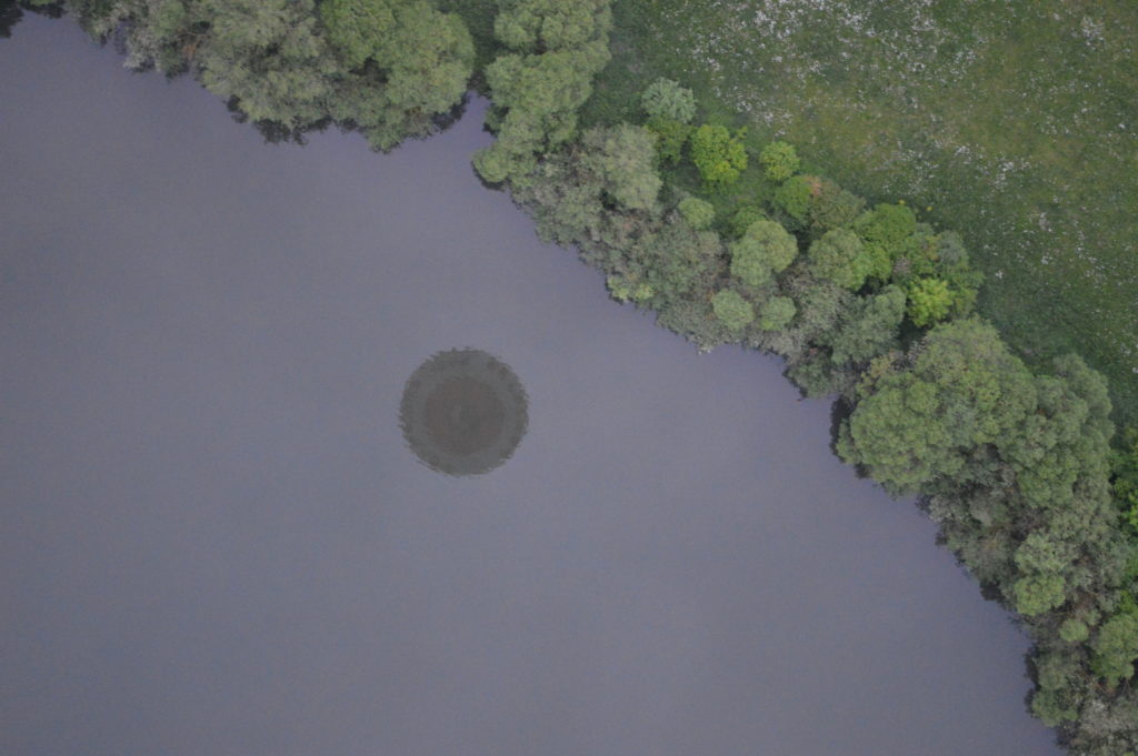 Reflection of the hot air balloon in a lake