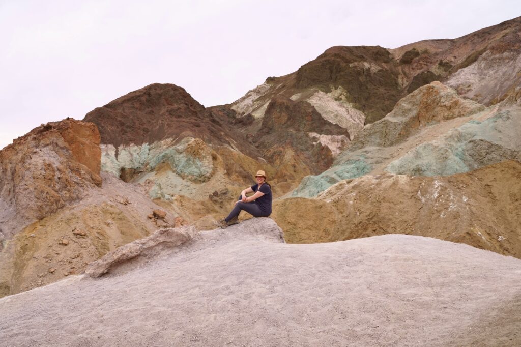 Woman sitting at Artists Palette in Death Valley National Park