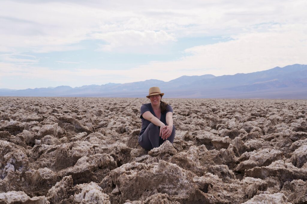 Woman sitting at Devils Golf Course in Death Valley National Park