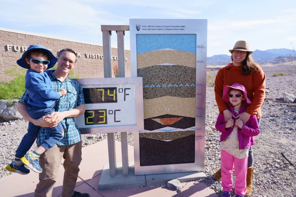 Family at Death Valley National Park visitor center thermometer