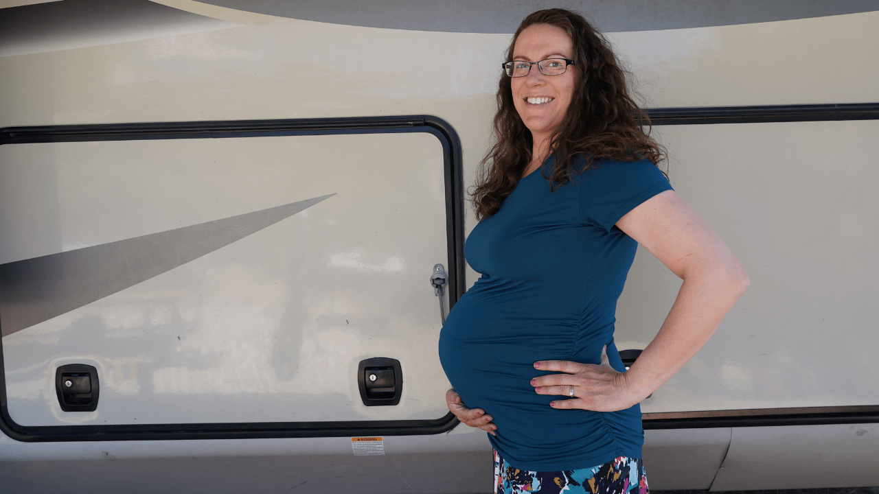 Woman in front of RV during pregnancy and full time RVing