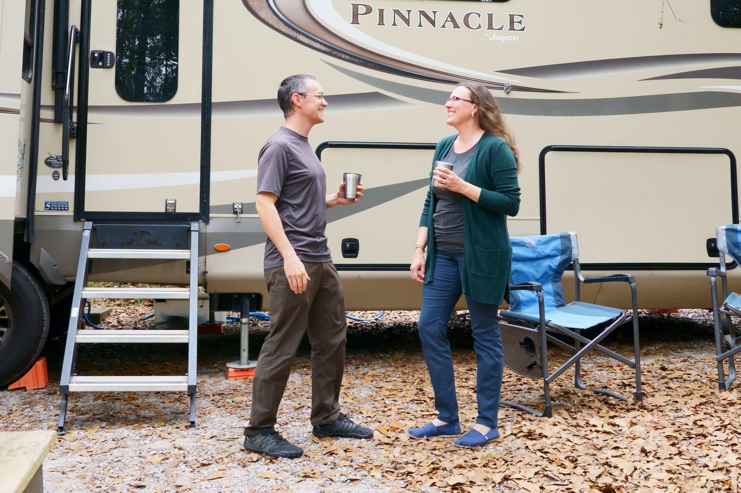 Man and woman in front of RV wearing KUHL travel pants