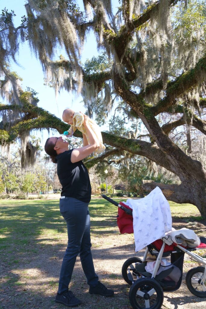 Woman lifting baby overhead