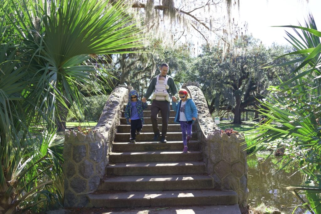 Dad with three children walking down stone staircase