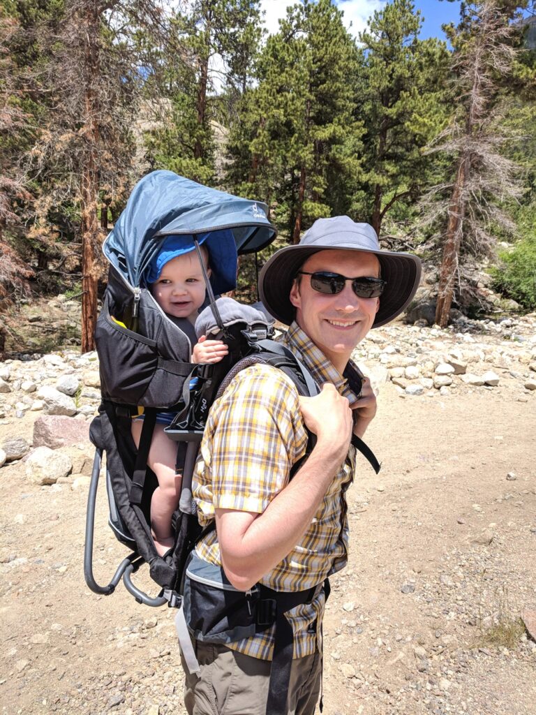 Man carrying baby in hiking pack
