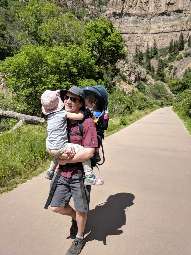 Man carrying both kids